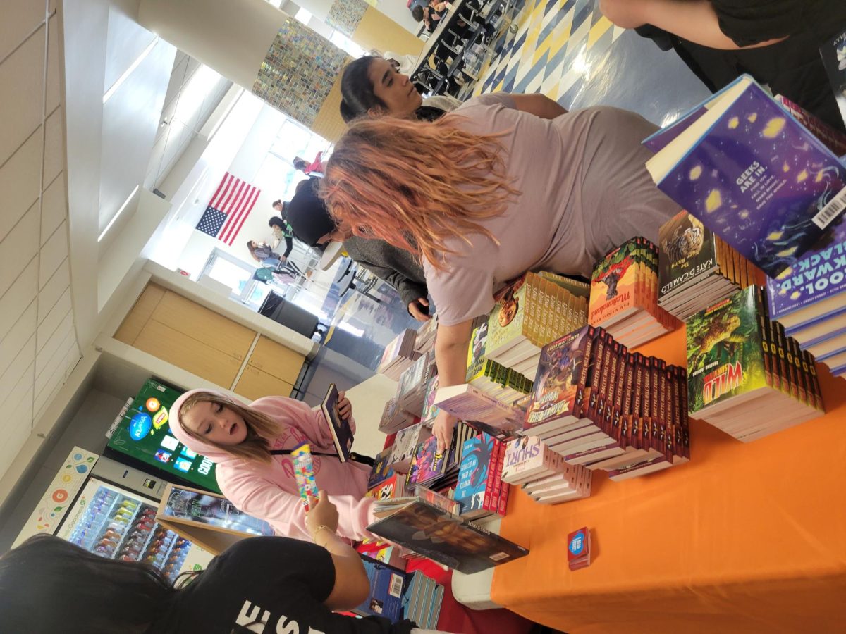 Students from Hancock Middle School pick out books provided free of charge by the Little Bit Foundation in the cafeteria on Thursday, February 27th. 