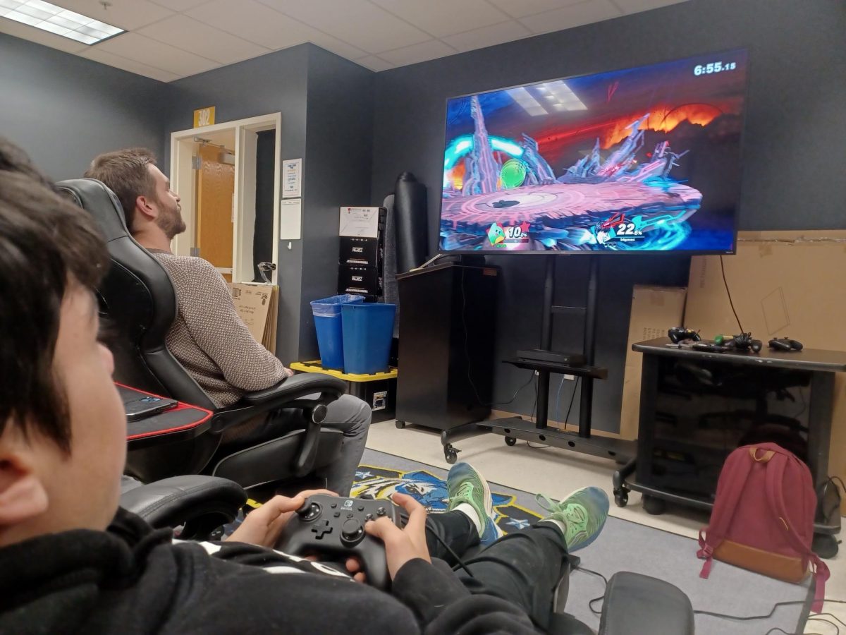 Junior Michael Cammann and Teacher Chad Hastings plays Super Smash Bros in the Gaming Room after school on Monday, the 15th.