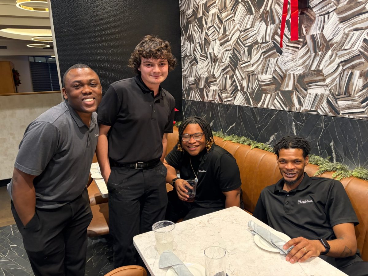 Freshman Earnest Corzine (middle on left) works at Bartolino's on The Hill, and is seen with his coworkers. 