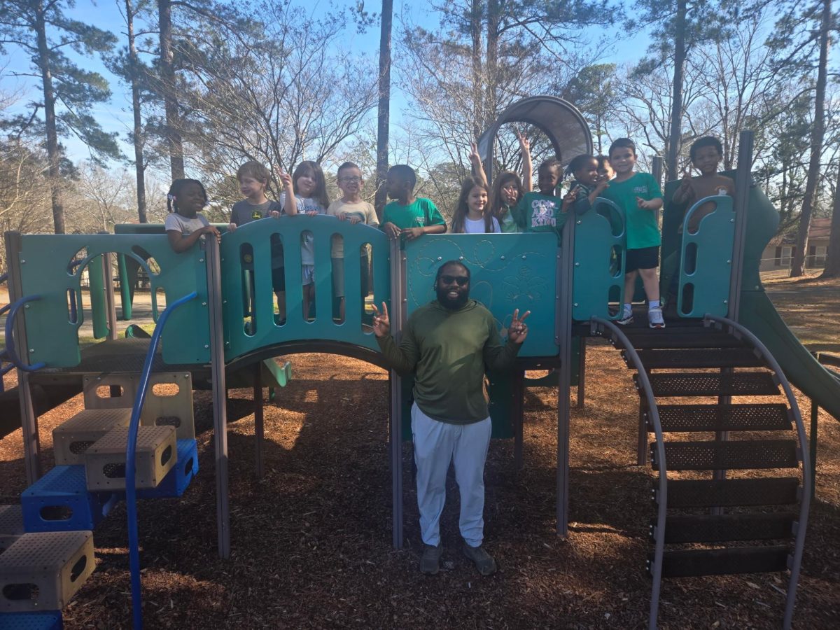 Mr. Kalik May poses with his class of  PE students at Faucett-Vestavia Elementary School.